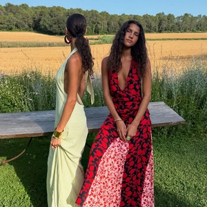Detail of backless polka dot and floral print maxi dresses in green and red colors