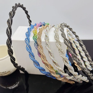 Detailed view of twisted headbands featuring multi-colored rhinestones on an alloy base