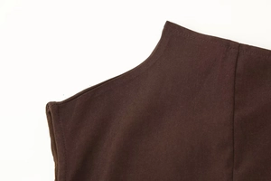 Detailed close-up of dark brown twill fabric with reinforced stitching on shoulder