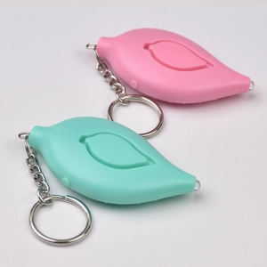 Detail of pink and mint green bird-shaped personal alarms with metal keychains