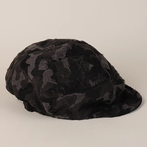 Detailed view of the distressed camouflage newsboy cap with retro frayed fabric edges