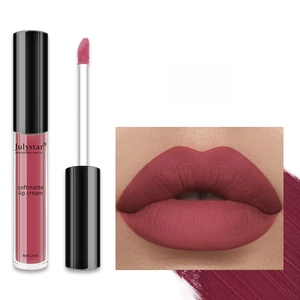 Macro view of matte lip glaze brush and dusty rose liquid lipstick swatch on lips