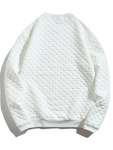 Macro detail of white long-sleeved shirt featuring waffle knit checkerboard texture