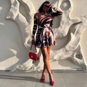 Detail of elegant off-shoulder floral mini dress with long raglan sleeves and retro pattern