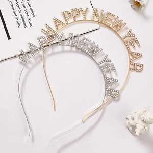 Detail of gold and silver HAPPY NEW YEAR headbands with sparkling rhinestones for parties