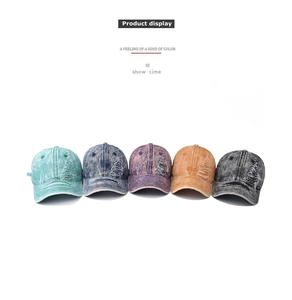 Detail of distressed washed denim baseball caps with vintage ripped effects in multiple colors