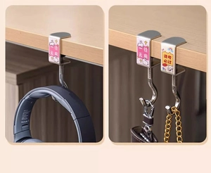 Adjustable metal desk hook with cartoon stickers showing headphone and bag storage