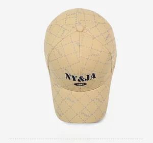 Top view of yellow baseball cap with plaid pattern and NY&JA 1987 embroidery detail