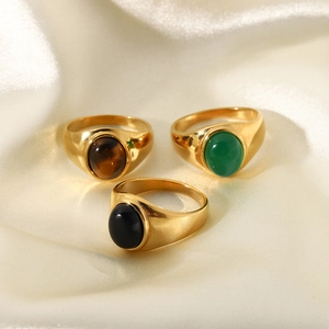 Three gold-plated titanium steel rings set with tiger eye, green, and black agate stones