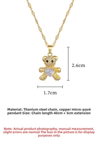 Macro view of gold teddy bear pendant featuring micro-pave crystals and heart-shaped stone