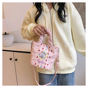 Pink canvas bucket bag with cute cartoon rabbit print and ruffled handle detail