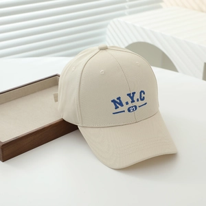 Close-up of blue N.Y.C 21 embroidery on beige cotton twill kids baseball cap