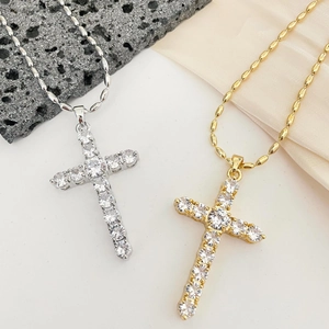 Cross pendant necklace with white cubic zirconia in gold and silver finish on silk