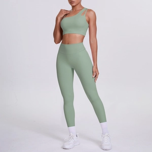 Detail of sage green one-shoulder sports bra and high-waisted yoga leggings set