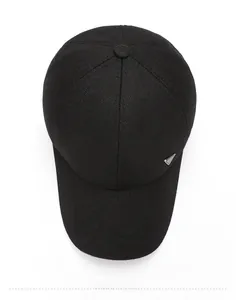 Top view of premium black wool baseball cap featuring a signature triangular metal logo