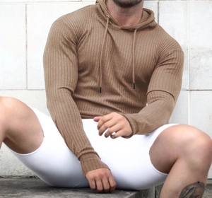 Detail of caramel brown ribbed knit hoodie showing soft texture and drawstring hood