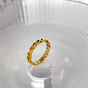 Detailed macro view of the hollow leaf pattern on a premium gold-plated ring