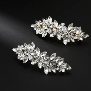 Detailed close-up of sparkling marquise crystal leaf hair clips with golden plating