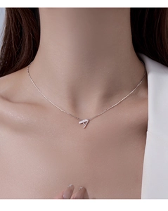 Macro view of a refined S925 silver necklace with a sparkling letter A pendant