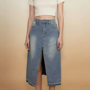 Detailed view of high waist denim skirt featuring front slit and vintage wash texture