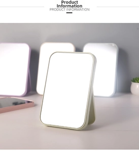 Close-up of portable desktop vanity mirrors with colorful plastic frames and folding stands