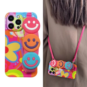 Detail of flower pattern silicone case with 3D smiley faces and woven pink wrist strap