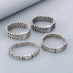 Macro shot of silver woven stainless steel chain bracelets with vintage magnetic clasps