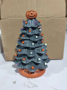 Close-up of Halloween ceramic tree featuring pumpkin topper and Trick or Treat text