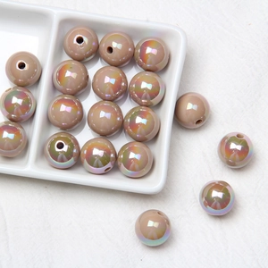 Macro shot of 16mm light brown acrylic beads with iridescent finish for DIY crafts