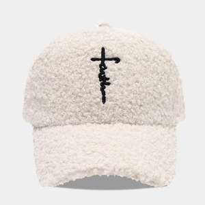 Detailed close-up of thick sherpa fleece fabric and faith cross embroidery on baseball cap