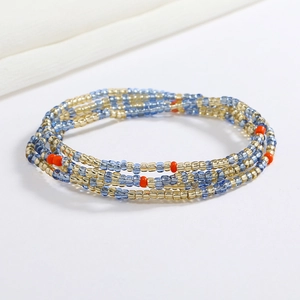 Detail of bohemian waist chain with colorful glass seed beads in blue and gold tones