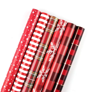6 rolls of Christmas wrapping paper with festive stars, stripes, and Scottish plaid patterns