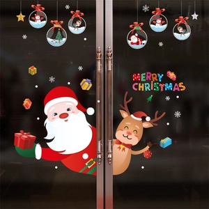 Detail of Santa and reindeer window stickers with Merry Christmas lettering on glass