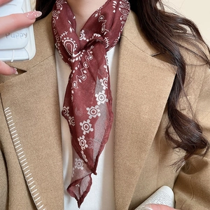 Close-up of wine red silk scarf necklace with bohemian patterns on a female model