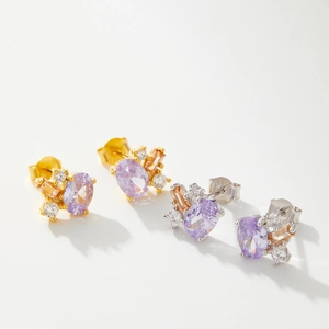 Detail of 925 silver earrings with purple oval stone and zircon pavé in gold and silver