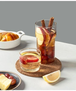 Macro shot of stacking borosilicate glass cups filled with fruit tea and cinnamon sticks