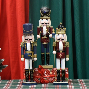 Three traditional Christmas nutcracker kings in pearl pink and blue for festive decor