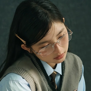 Chic rimless square blue light blocking glasses with gold metal temples on a female model