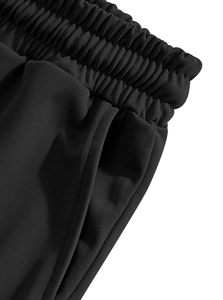 Detail of elastic drawstring waist and side pocket on black linen casual pants