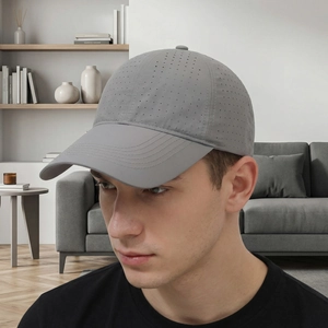 Grey breathable outdoor sports baseball cap with laser-cut holes on a male model