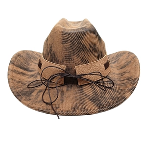 Detail of vintage western cowboy hat with brown tie-dye pattern and leather band