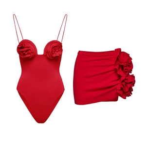 Detail of red one-piece swimsuit and mini skirt set with large 3D rose flower accents