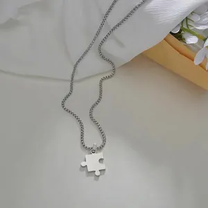 Detailed view of polished silver puzzle pendant necklace on a refined gift background