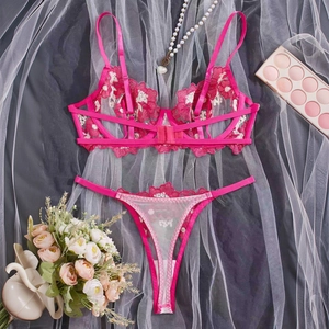 Detailed flat lay of rose red lace lingerie set with white floral embroidery and mesh