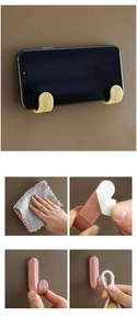 Installation guide for yellow adhesive J-hooks showing steps and usage as a phone holder