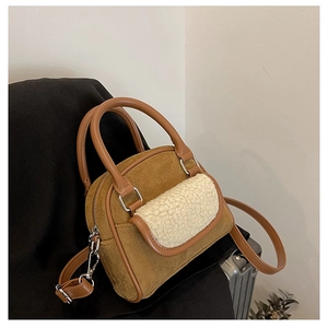 Detail of camel plush crossbody bag featuring textured suede fabric and shearling pocket