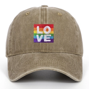 Detailed view of LOVE rainbow embroidery on vintage washed cotton baseball cap texture
