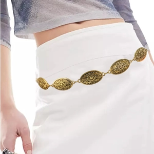 Detailed close-up of vintage gold metal chain belt with turquoise and oval engraving