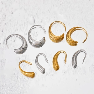 Polished C-shape and teardrop earrings with liquid metal texture on water droplet surface