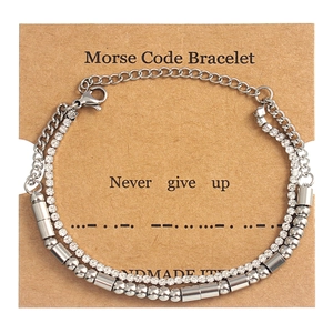 Detail of double-layer Morse code bracelet with crystals and 'Never give up' card